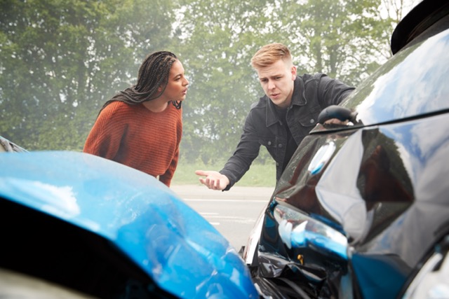 Two Angry Motorists Arguing Over Responsibility For Car Accident